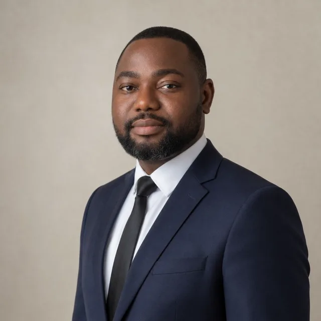 Lanre Awe in a navy suit and tie